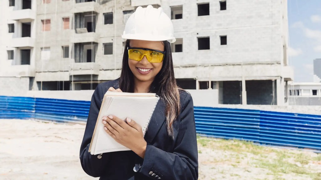 Femme afro-américaine souriante avec un casque de sécurité